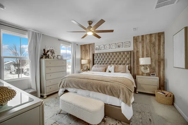 a bedroom with a bed and wooden floor