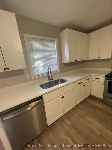 a kitchen with a sink cabinets and window