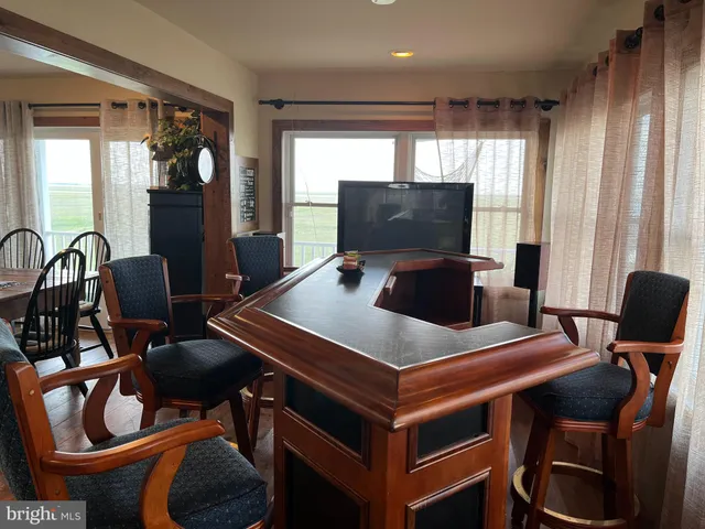 a living room with furniture a ceiling fan and a window