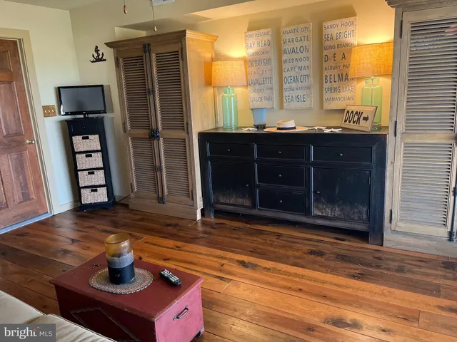 a bathroom with a granite countertop sink mirror vanity and toilet