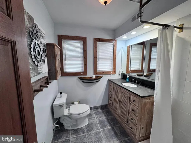 a view of a hallway view with wooden floor and staircase