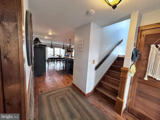 a view of entryway and hall with wooden floor