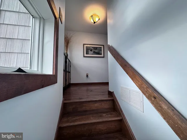 a bedroom with a large bed and a large window