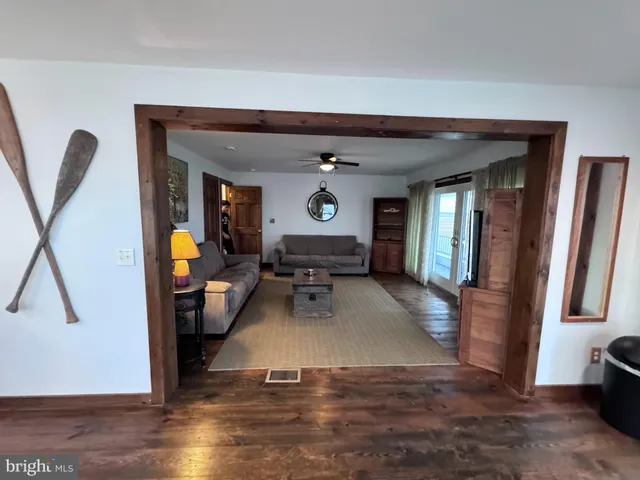 a living room with furniture wooden floor and a flat screen tv
