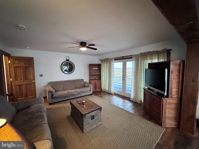 a view of living room with furniture and a wooden floor