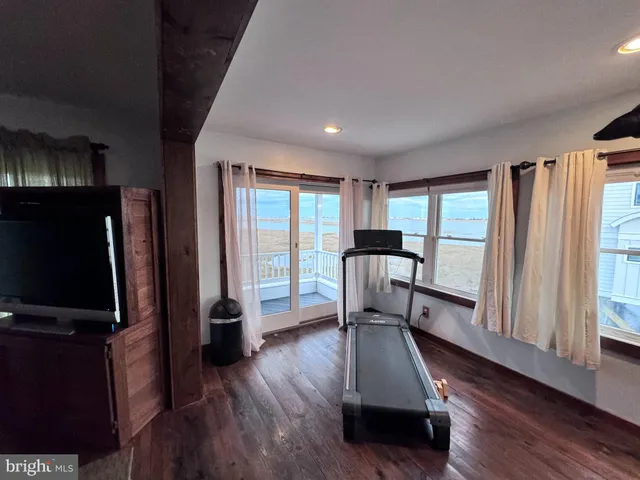 a view of entryway with a large window and wooden floor