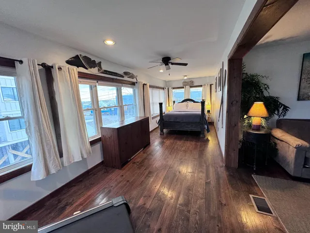 a view of a living room with furniture and wooden floor