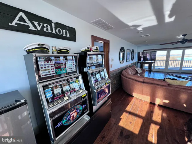 a living room with furniture large window and wooden floor