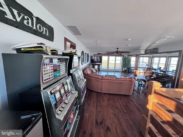 a balcony with wooden floor outdoor seating and barbeque oven