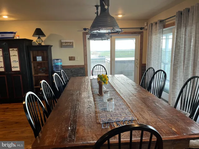 a dining room with furniture window and wooden floor