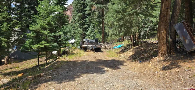 a view of outdoor space with deck and trees