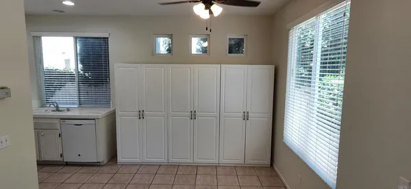 an empty room with windows and fireplace