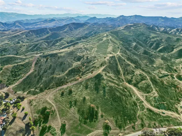 a view of a lush green hillside and a houses
