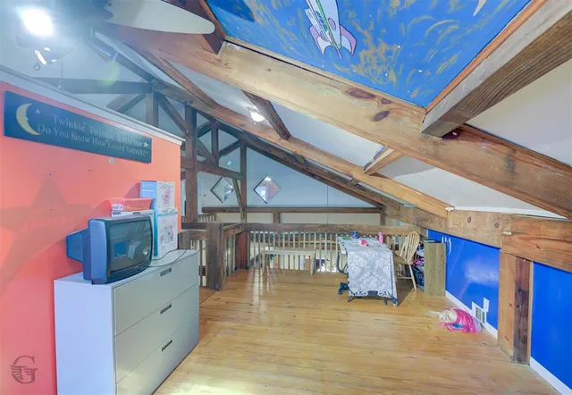 a bedroom with furniture and wooden floor