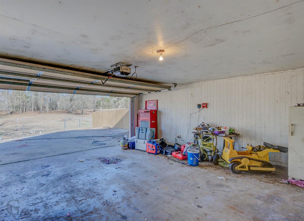 120 Bella Vista Loop Homer, LA 71040 - Photo 26 of 27 Garage featuring wooden walls and a garage door opener