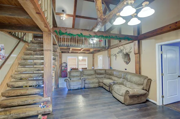 a living room with furniture and a chandelier