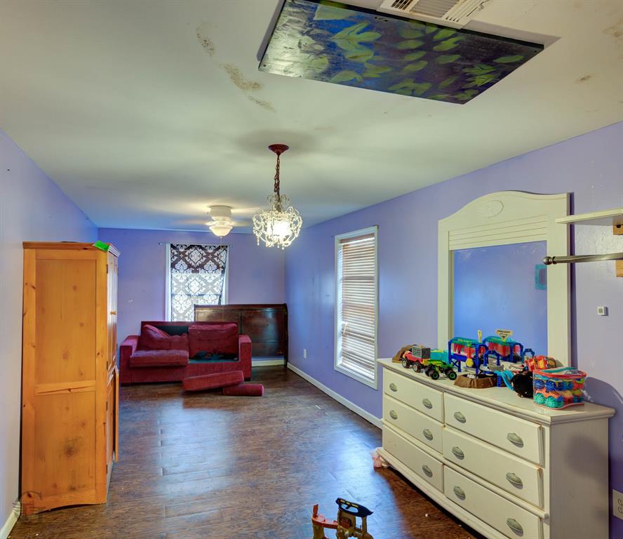 120 Bella Vista Loop Homer, LA 71040 - Photo 8 of 27 Bedroom featuring dark wood finished floors and a chandelier