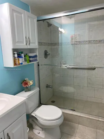 a bathroom with a shower and a toilet