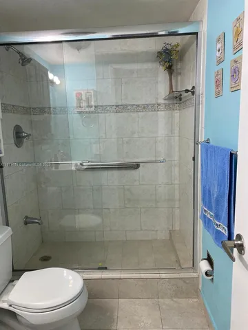 a bathroom with a sink vanity mirror and toilet