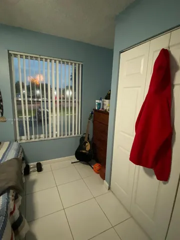 a bed room with a bed and a television