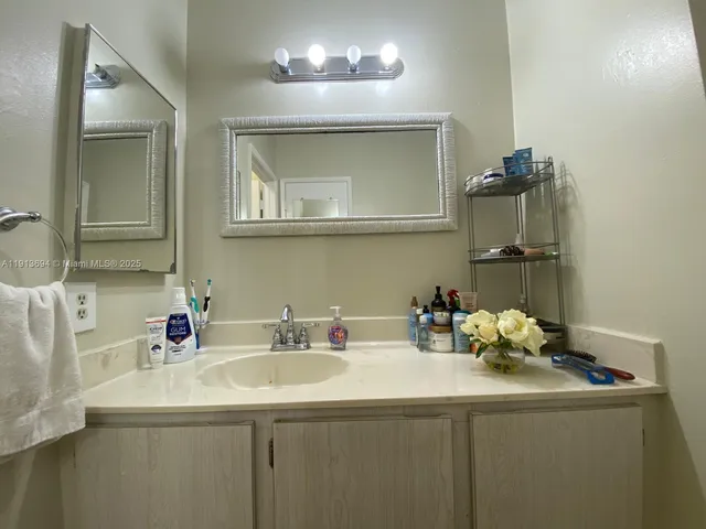 a room with a sink and a wooden floor