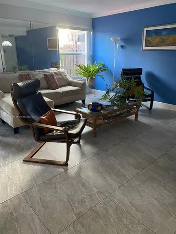 a kitchen with stainless steel appliances kitchen island granite countertop a sink and a refrigerator