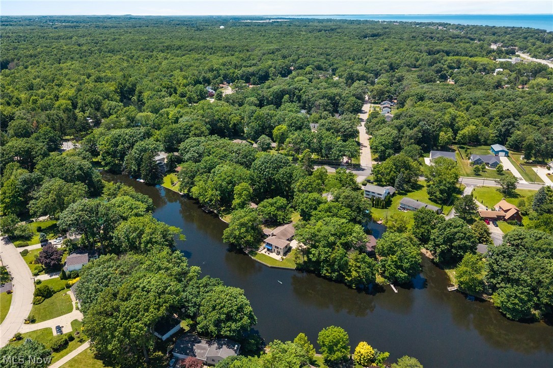 685 Sunnyside Road Vermilion, OH 44089 - Photo 47 of 50 Aerial perspective showcasing a water feature surrounded by lush, mature trees
