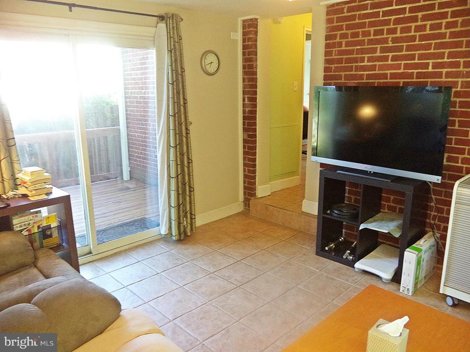 12714 Holdridge Road Silver Spring, MD 20906 - Photo 13 of 30 Family Room to rustic BRICK WALL, Sliders to DECK