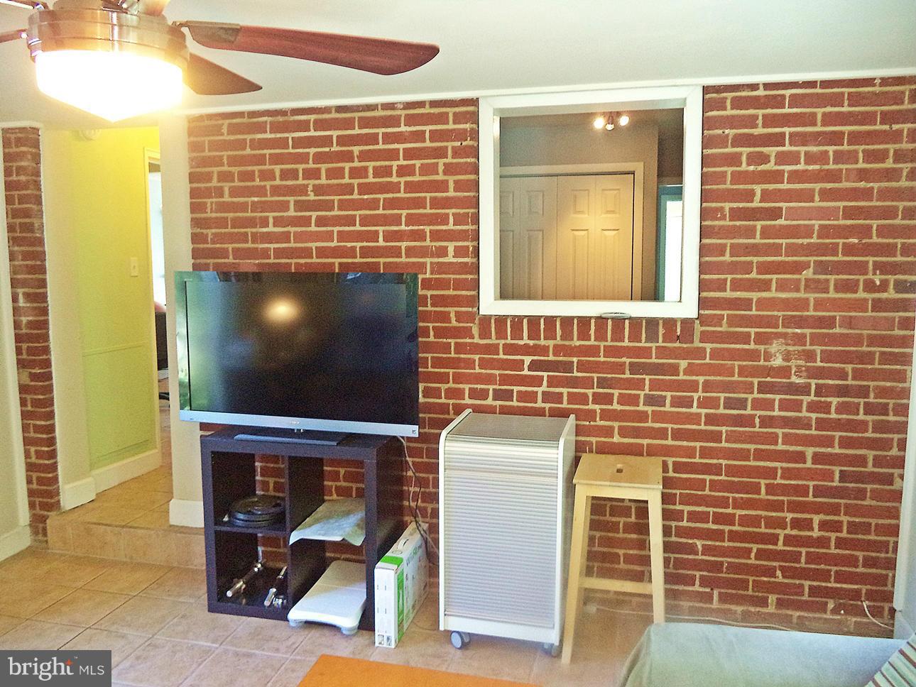 12714 Holdridge Road Silver Spring, MD 20906 - Photo 14 of 30 Family Room to rustic BRICK WALL Sliders to DECK