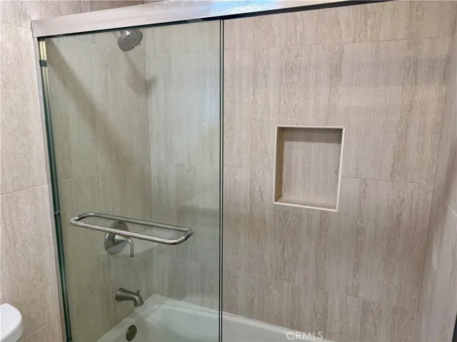 a bathroom with a shower and a sink