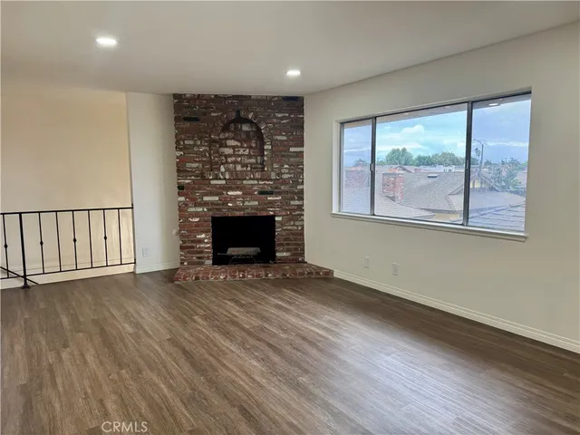 wooden floor in an empty room with a fireplace