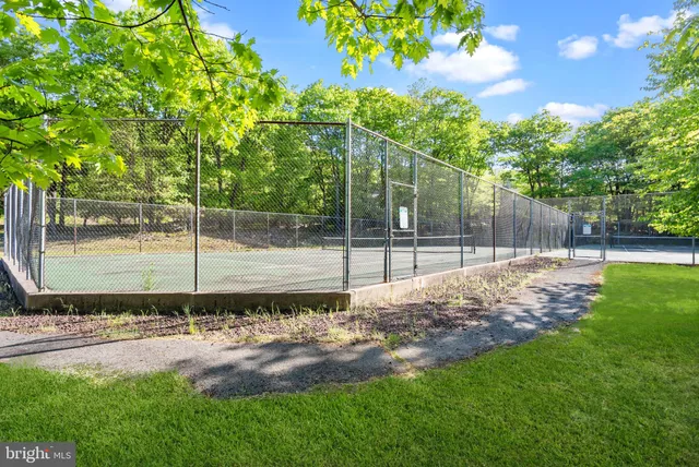 an outdoor space with seating area and trees
