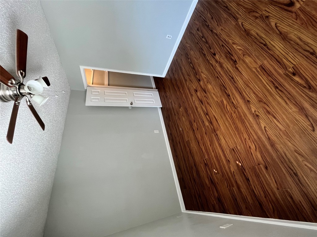 4906 West Gate Boulevard, Unit 104 Austin, TX 78745 - Photo 13 of 22 Unfurnished room featuring a textured ceiling, dark wood-style flooring, and ceiling fan