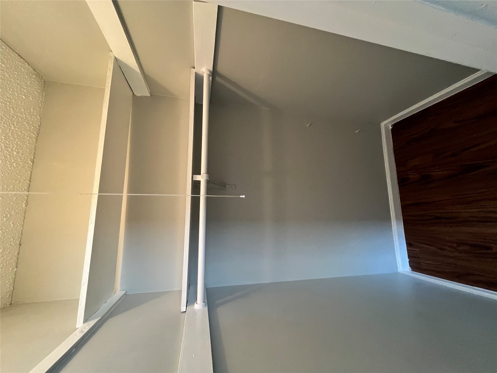 4906 West Gate Boulevard, Unit 104 Austin, TX 78745 - Photo 15 of 22 Walk in closet featuring dark wood finished floors
