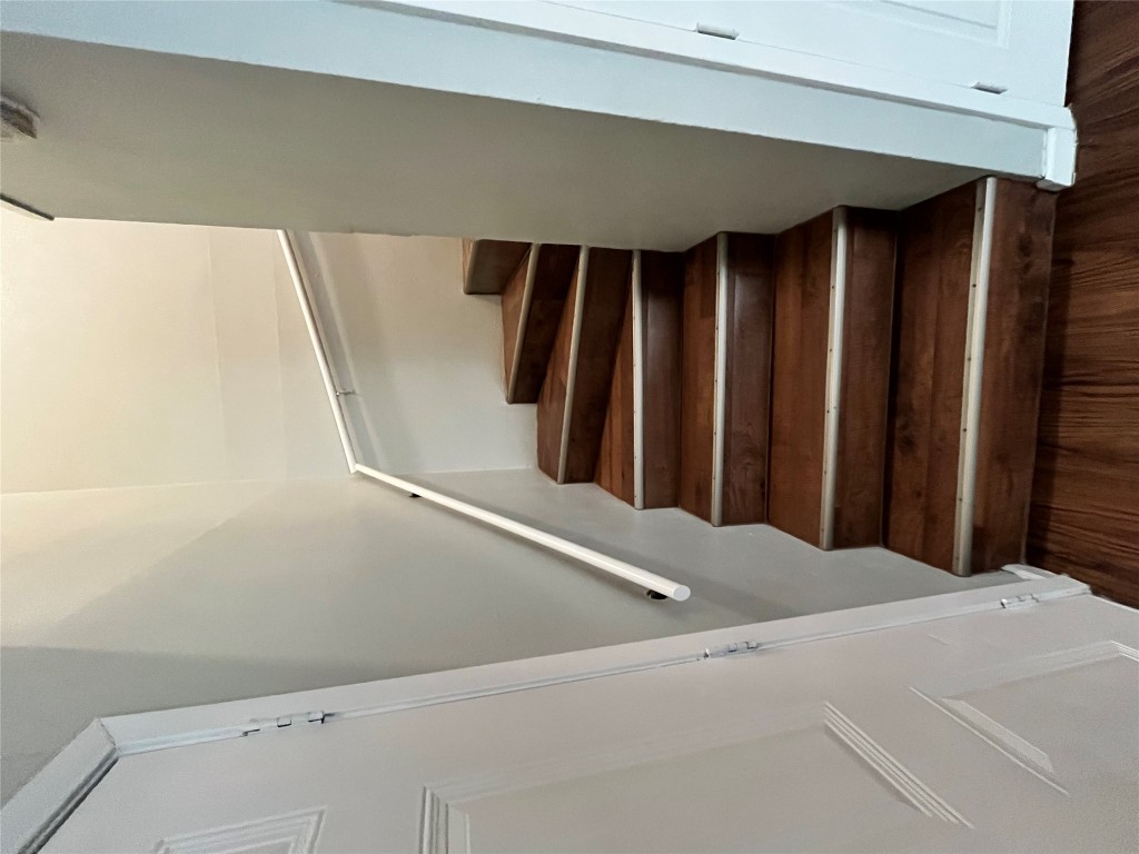 4906 West Gate Boulevard, Unit 104 Austin, TX 78745 - Photo 5 of 22 Stairs featuring wood finished floors and baseboards