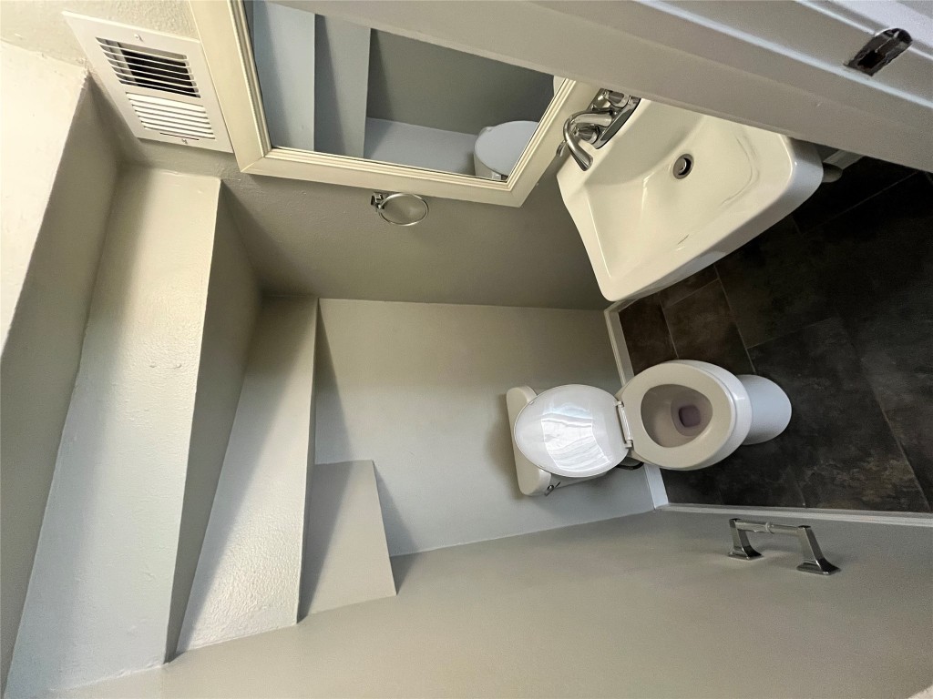 4906 West Gate Boulevard, Unit 104 Austin, TX 78745 - Photo 7 of 22 Half bath with toilet and baseboards