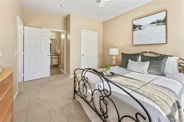 a bedroom with a bed and paintings on the wall