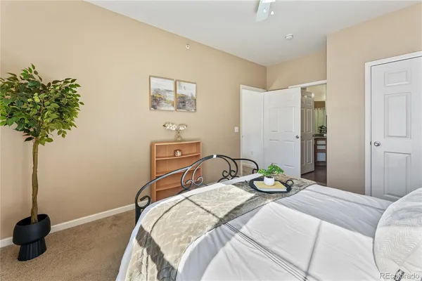 a bedroom with a bed and a potted plant
