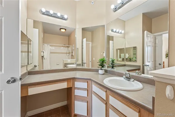 a bathroom with a sink double vanity granite and a mirror