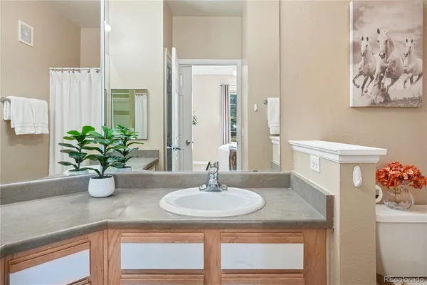 a bathroom with a sink a vanity and a mirror