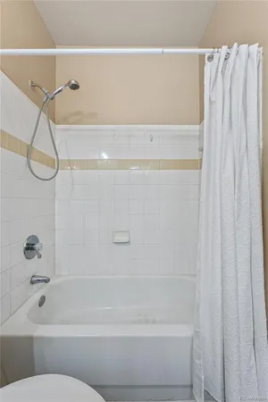 a bathroom with a shower and a bath tub