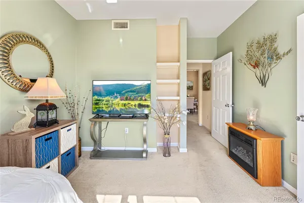 a view of living room with furniture and a fireplace