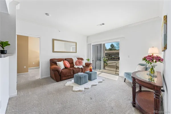 a living room with furniture a window and a flat screen tv