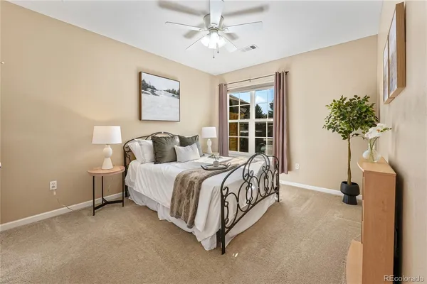 a bedroom with a bed and a potted plant