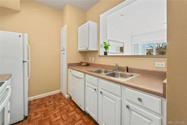 a kitchen with a sink and a refrigerator