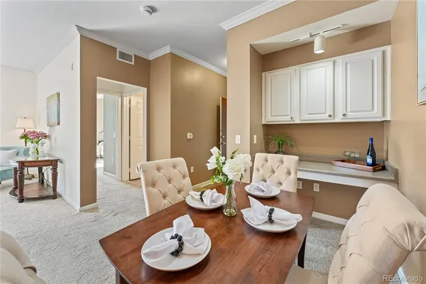 a kitchen with furniture and a wooden floor