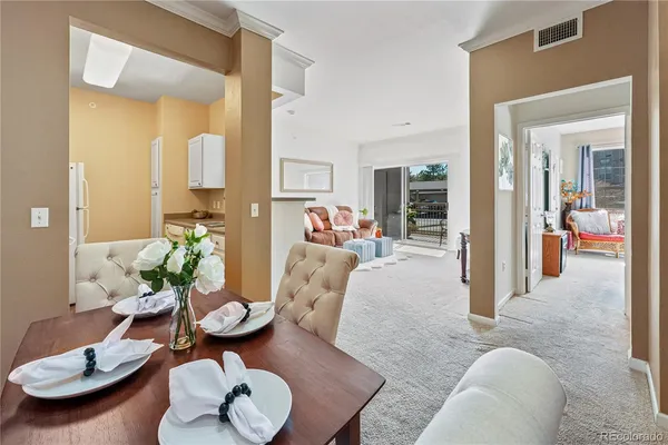 a living room with furniture and a dining table