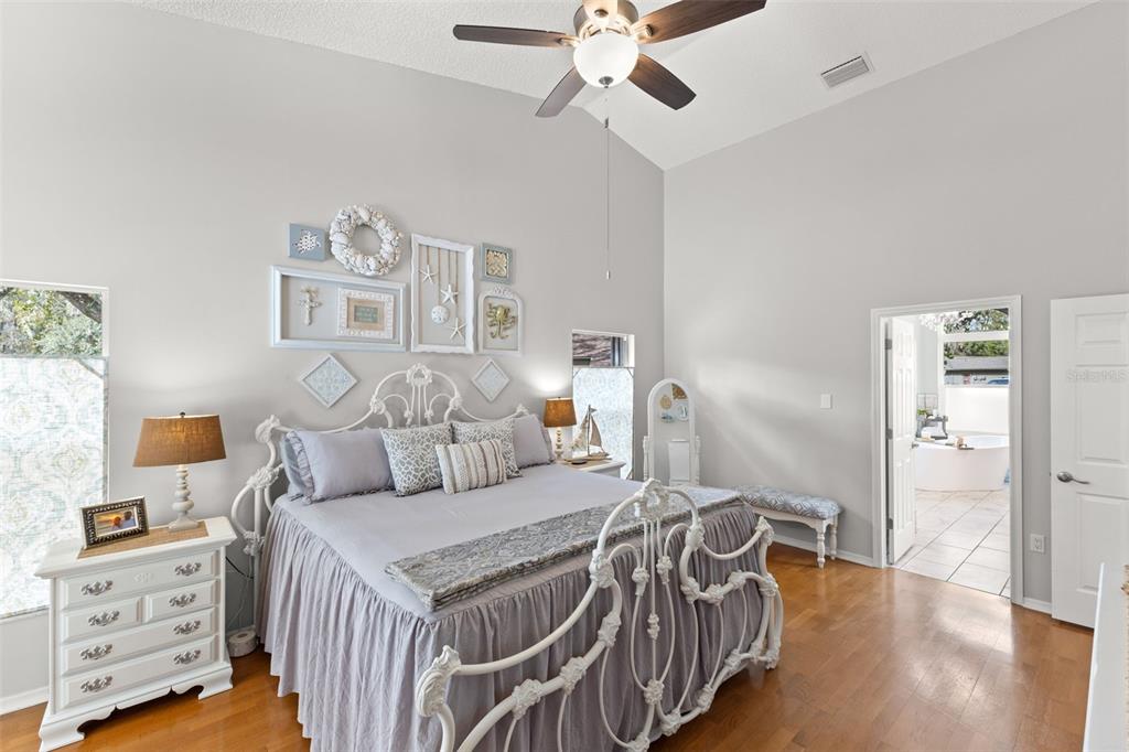 3734 Thornbush Lane New Port Richey, FL 34655 - Photo 22 of 47 a bedroom with a bed and wooden floor