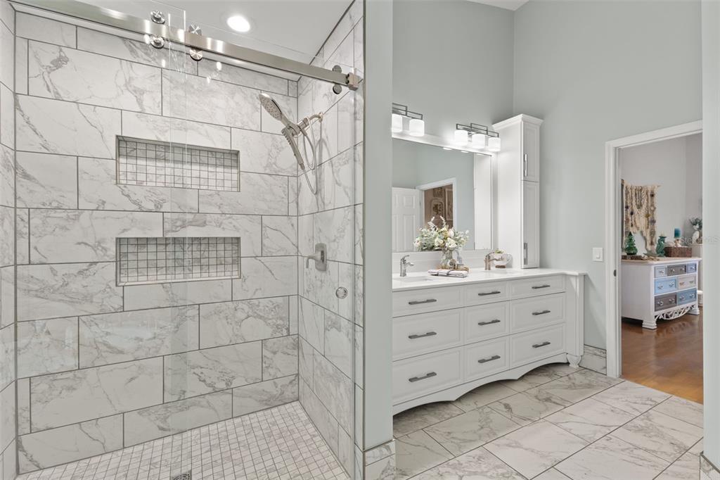 3734 Thornbush Lane New Port Richey, FL 34655 - Photo 24 of 47 a bathroom with a shower a sink and a mirror