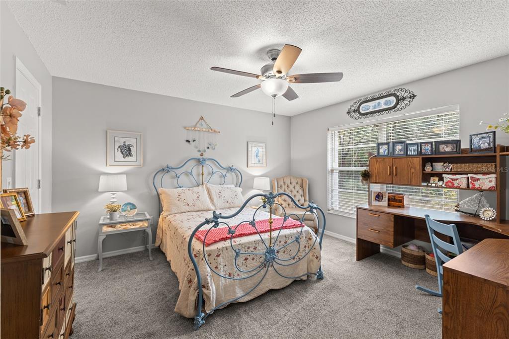 3734 Thornbush Lane New Port Richey, FL 34655 - Photo 26 of 47 a bedroom with a bed and a chandelier